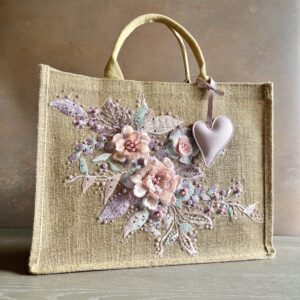Blush floral jute gift bag with pastel embroidered flowers, bead detailing and heart charm – Pomme d’Or.