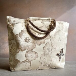 Floral occasion bag with gold jacquard fabric, beaded handles and butterfly embellishment – Pomme d’Or.