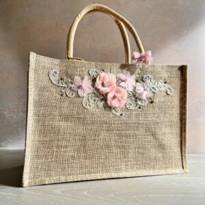 Hand embellished floral jute gift bag with pink blossom appliqué and decorative embroidery by Pomme d’Or.