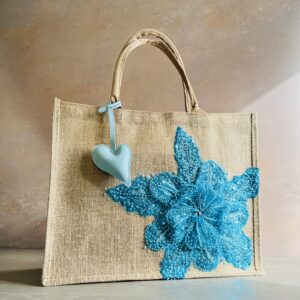 Turquoise floral jute gift bag with sequin flower embellishment and heart charm – Pomme d’Or.