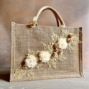 Gold lace floral jute gift bag with lace floral appliqué, organza flowers and pearl bead detailing – Pomme d’Or.