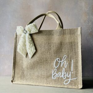 Baby shower gift bag with pearl bow in pink and white with “Oh Baby” design – Pomme d’Or, large white featured.