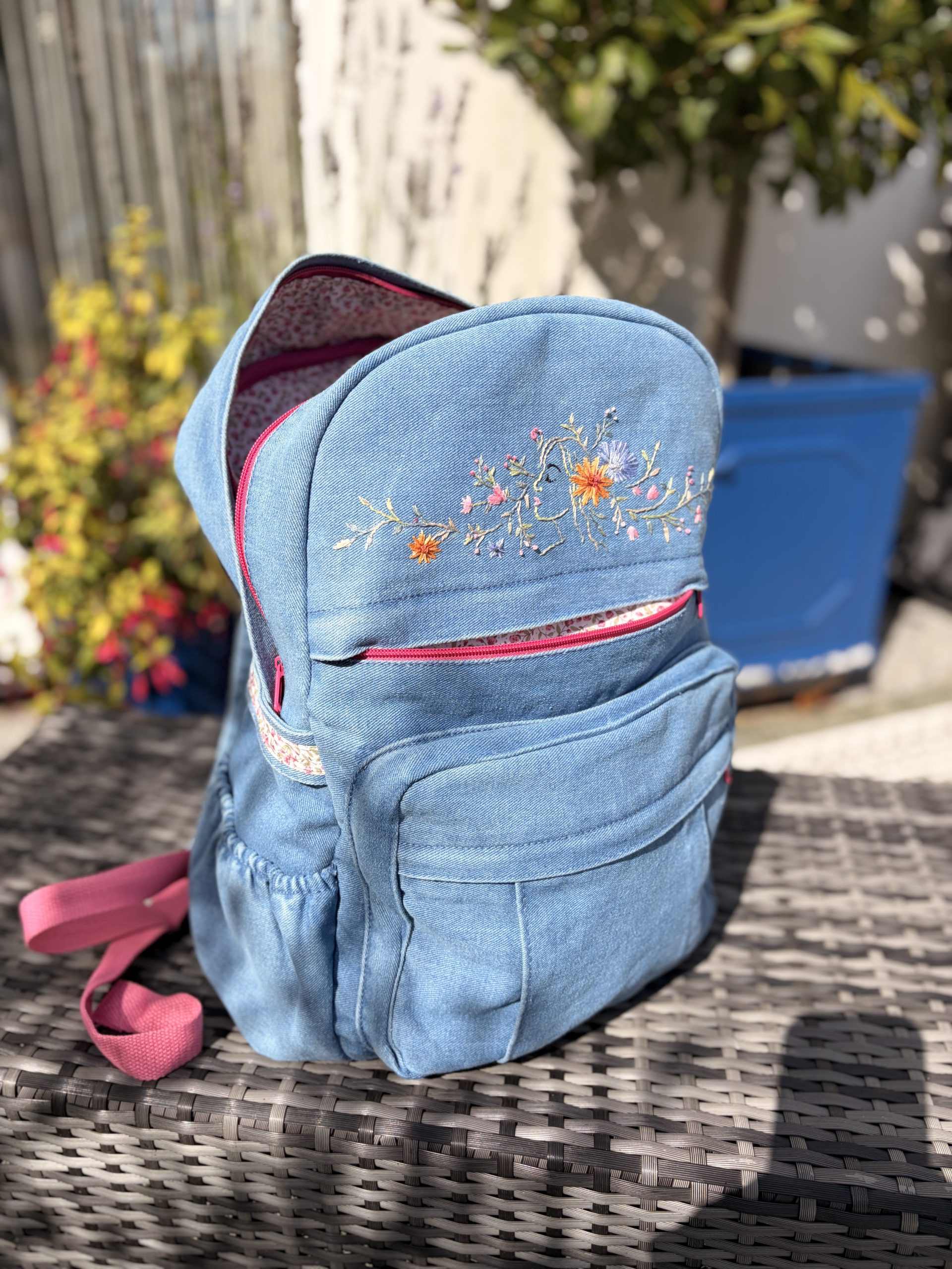 Gaia denim backpack with floral embroidery, pink zips and floral lining