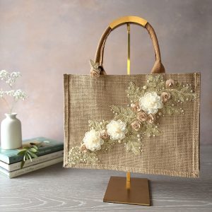 Gold lace floral jute gift bag with lace floral appliqué, organza flowers and pearl bead detailing – Pomme d’Or.