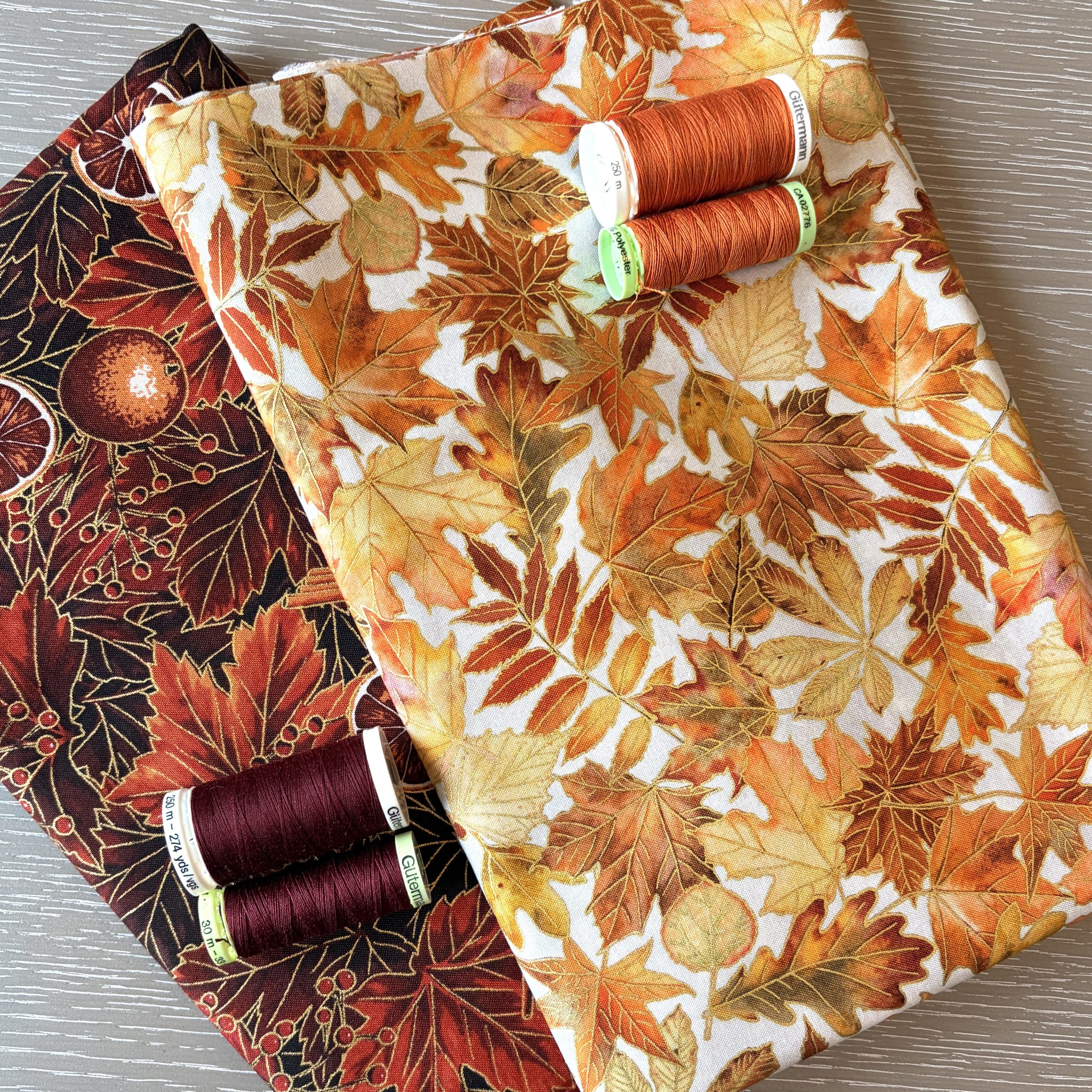 Autumn leaf fabrics and threads for handmade bag making at Pomme d'Or