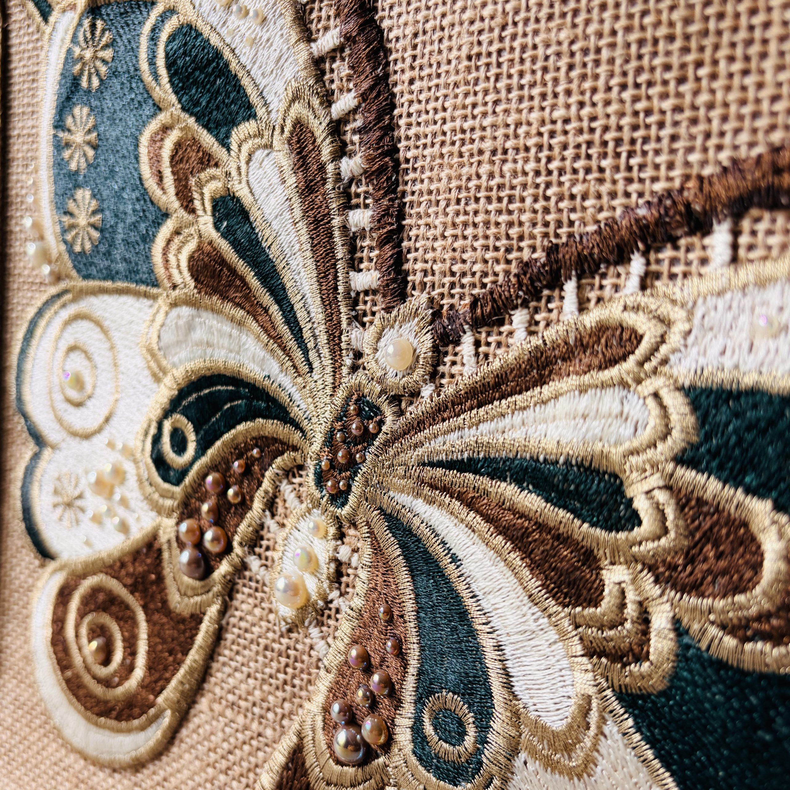 Close-up of the embroidered centre and wings of the butterfly appliqué on Sylvan jute bag.