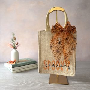 Halloween jute bag with orange spider web bow and embroidered Spooky Season design, hand embellished by Pomme d’Or.